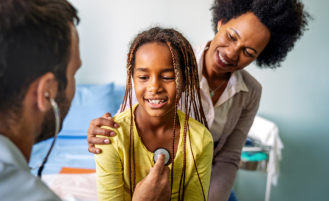 Doctor examines young patient.