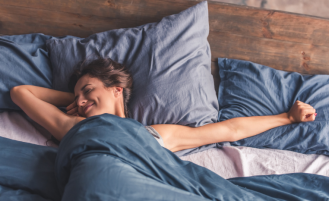 Woman waking up after restful night's sleep.