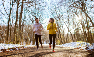 Couple running outside in winter.