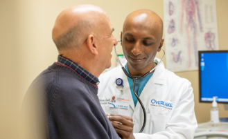 Overlake cardiologist listens to patient's heart.