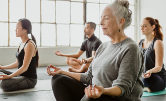 Older adult in yoga class.