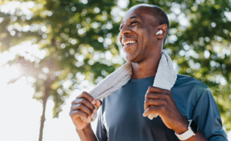 Man with earpods cools off from run.