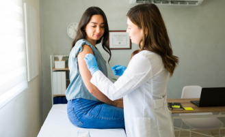 Doctor prepares vaccine for patient.