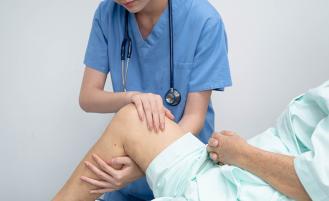 Provider examining patient's knee