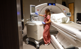 Nurse uses CT equipment