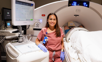 Nurse with new CT equipment