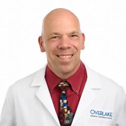 Dr. Lawrence Madewell headshot in white coat