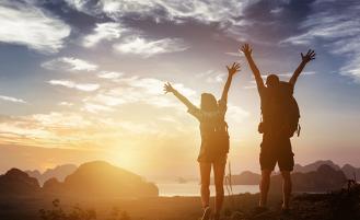 Two hikers celebrating a successful hike