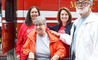 Group of people in front of a first responder truck