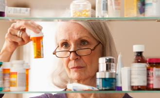 Person cleaning out medicine cabinet 