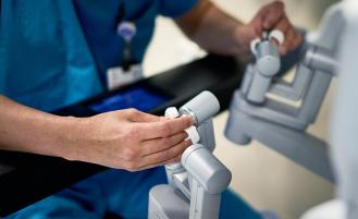 Surgeon operating a robot