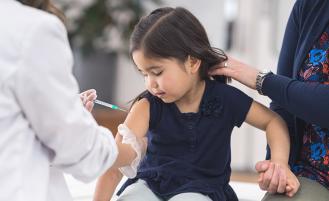 young-girl-getting-vaccine-from-doctor