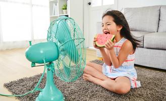 young-girl-eating-watermelon-front-of-fan