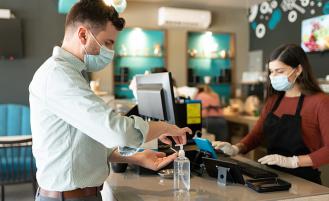 man-using-hand-sanitizer-at-store