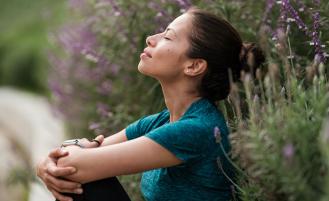 woman-with-closed-eyes-sitting-outdoors-peacefully