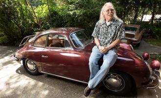Walt-sits-on-hood-of-vintage-car