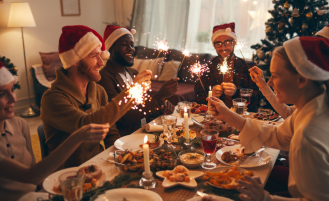 People sitting at table at holiday dinner party