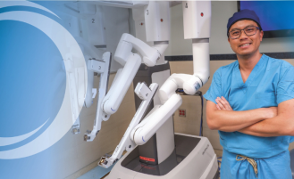 Dr. Pham with robotic surgery equipment.