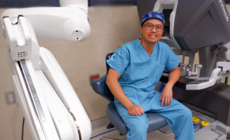 Dr. Pham with robotic surgery equipment.